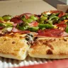 Boston Pizza International - medium deluxe pizza wasn't as stated