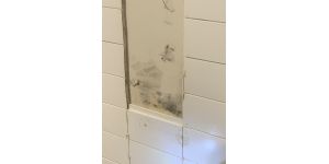 Ryan Homes - Drilled a nail into a drainage pipe when installing a toilet paper holder.