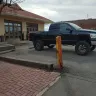 Burlington Northern Santa Fe [BNSF] - this parking lot has piece of railroad used as a safety pole