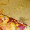 Debonairs Pizza - Pizza had a wire from a wire brush