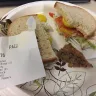 Wawa - tuna sandwich on rye with some type of paper in sandwich - Photo 1