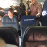WestJet Airlines - a very large dog (a labradoodle) boarded on flight with a mother and small child in the cabin - Photo 3
