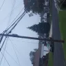 Optimum - wire left hanging from pole on front lawn